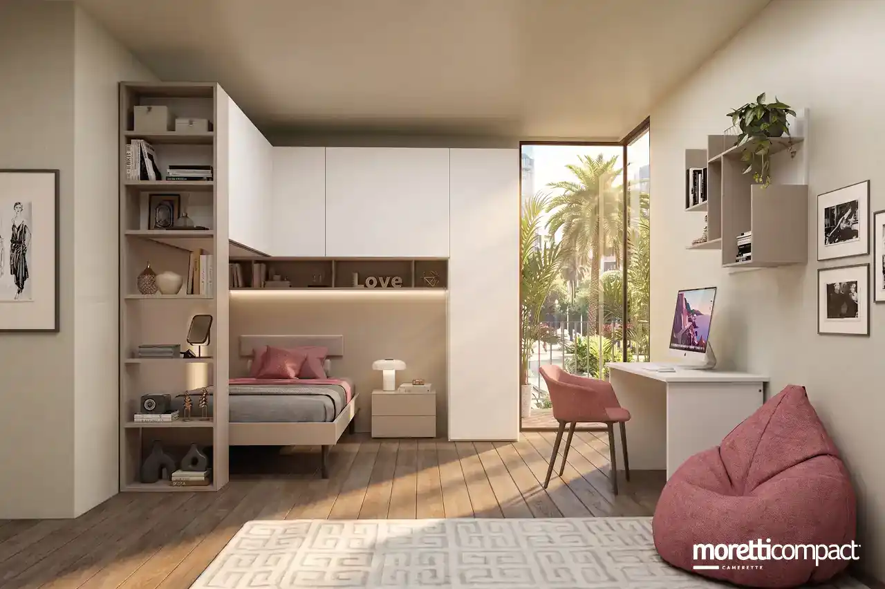 Armadio a ponte angolare con terminale a giorno, letto a una piazza e mezza e zona studio con libreria.